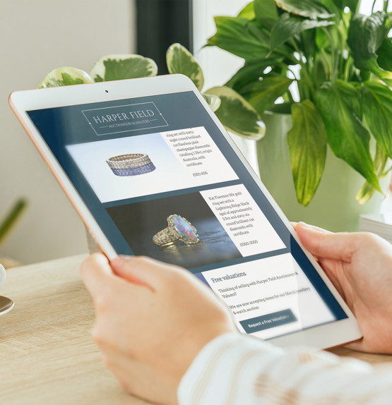 Person using a tablet to look at an email from Harper Field