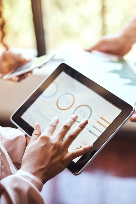 Two people looking at data on screens